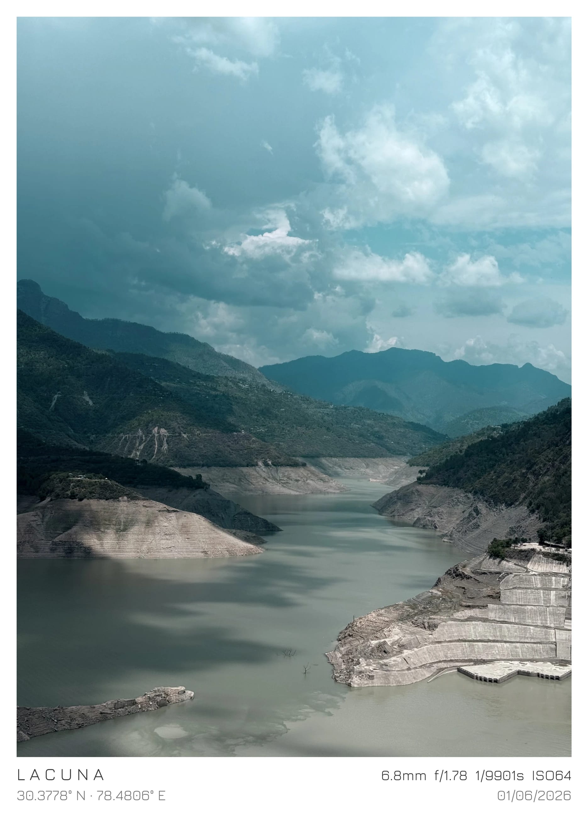 A pale river winding through a deep mountain valley