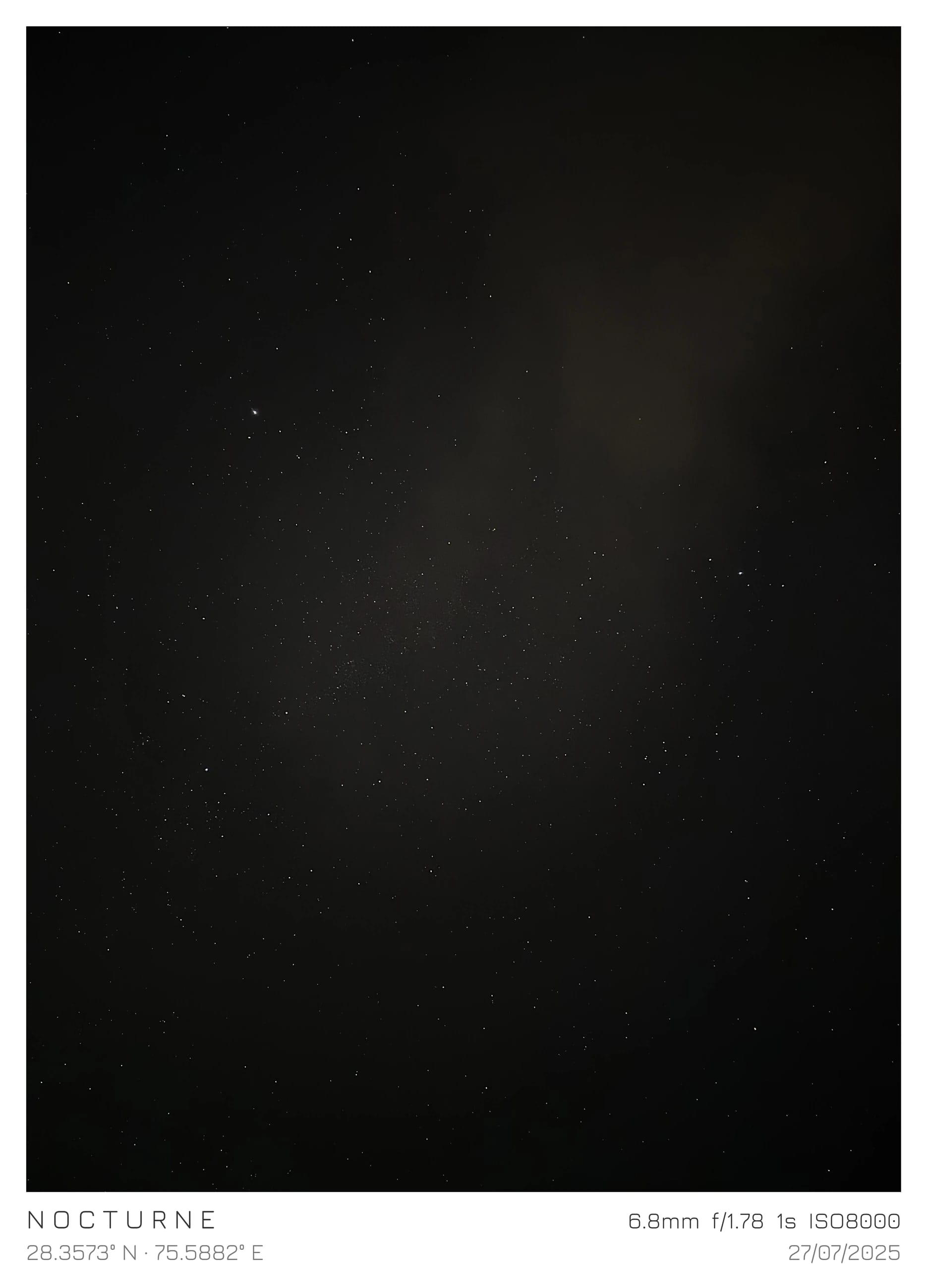 A faint moon emerging through a dark clouded sky