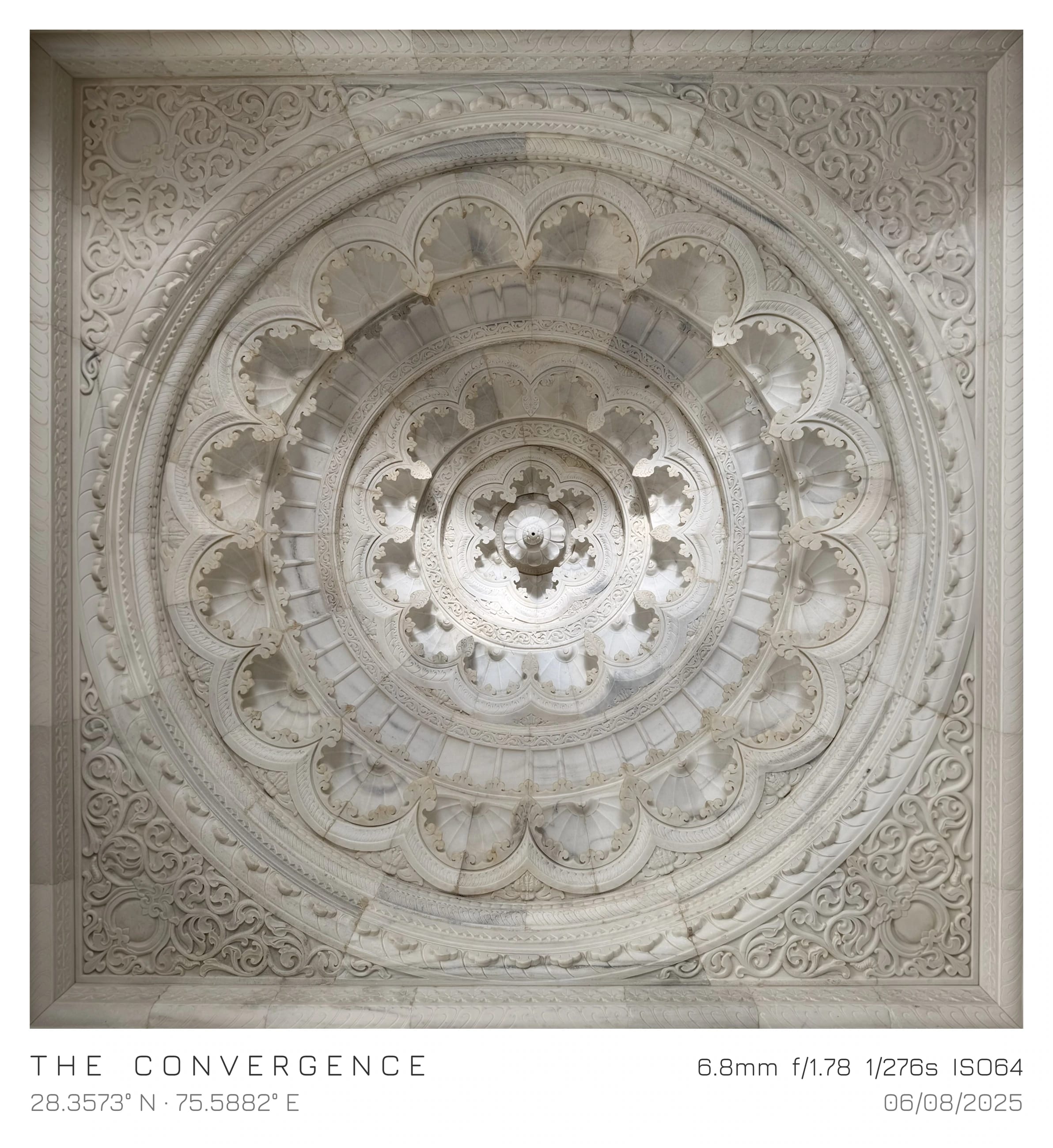 An ornate circular ceiling carved in pale stone